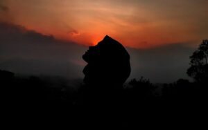 silhouette of person against sunset sky